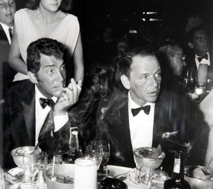 Frank Sinatra (right) and his buddy Dean Martin in a classic pose; smoking and drinking on a night out.